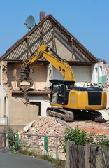 demolition of a house with a chain excavator