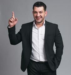 Handsome happy businessman gesture his finger up