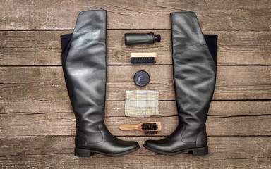 Elegant boots with polish cream and brushes
