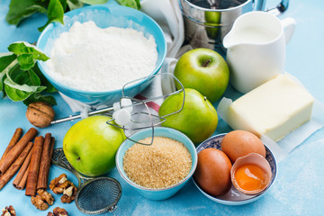 Apple pie ingredients on kitchen table. Space for text
