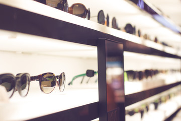 sunglasses on light shelves