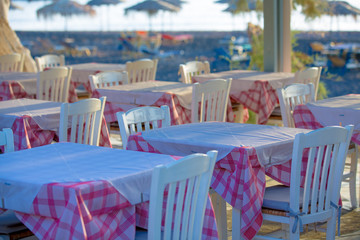 Tables and chairs in a street restaurant in Kamari on Santorini