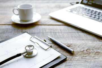doctor workplace with a stethoscope at wooden table