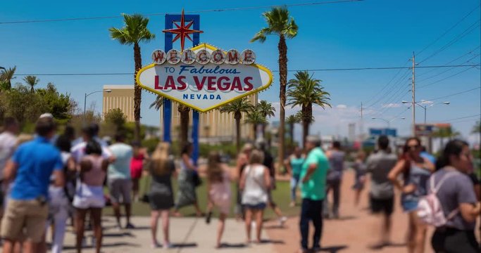 Las Vegas Welcome Sign Time-Lapse People Blur. Time-lapse of tourists take photos in front of the famous Las Vegas welcome sign on a hot summer day
