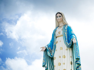 Obraz na płótnie Canvas The Blessed Virgin Mary Statue blue sky background.
