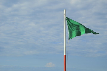 Green Safety Flag on the beach