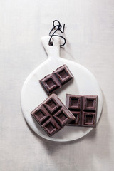 close up a chocolate bar on white marble board