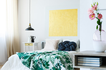 Guest bedroom with yellow artwork