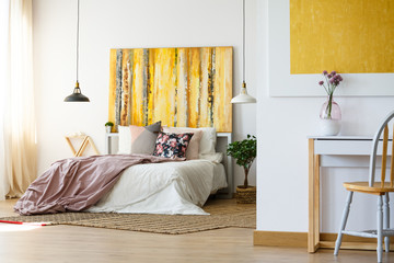 Energetic bedroom with yellow artwork