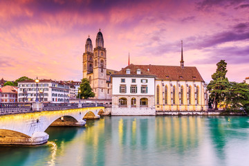 Fototapeta premium Zurich, Switzerland. View of the historic city center with famous Grossmunster Church, on the Limmat river.