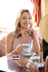 Beautiful young women drinking coffee in cafe