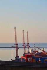 Three cranes of the port terminal near Salerno, Italy at dawn