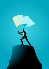 Businessman holding a flag on top of rock