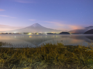 beautiful night view before sunrise from mountain fuji at kawaguchiko lake japan with soft focus foreground
