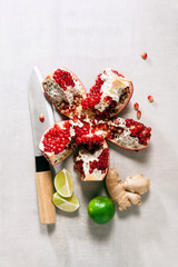 Knife and food ingredients on white stone table top view