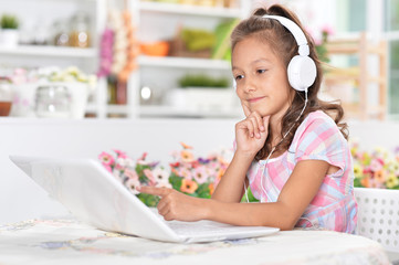 girl in headphones using laptop