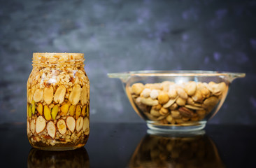 Different kinds of nuts on dark background