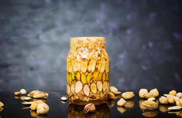 Different kinds of nuts on dark background