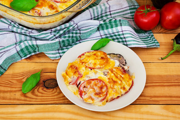 Eggplant casserole. Moussaka on wooden background