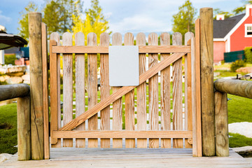 wooden door or fence with empty white tag or caution board