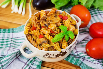 Pasta with vegetable sauce on wooden background
