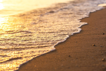 Soft waves on the sand at sunset.Selective focus.