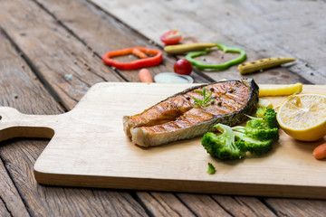 Salmon fillets. Grilled salmon, salmon steak on old wooden table, vintage style