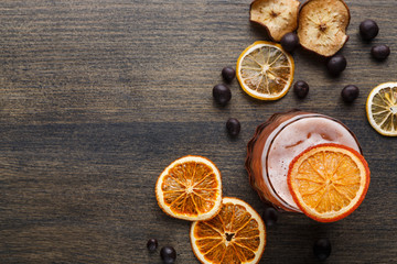 Obraz na płótnie Canvas Orange cocktail with citron on wooden background