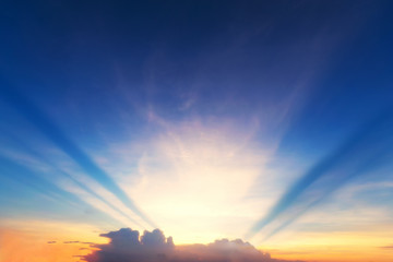 Sky background at sunset,Sky blue and orange light of the sun through the clouds in the sky