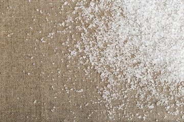 Large sea salt scattered on sackcloth in the right corner.