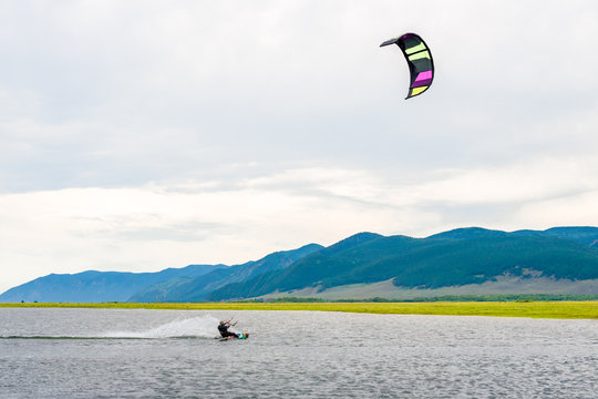 Athlete train by kitesurfing on the lake 