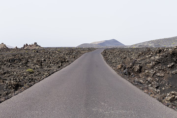 cloudy day and road as travel background. volcanic scenery. white sky