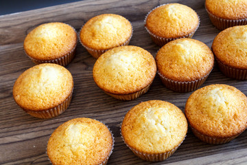 freshly baked muffins cupcakes on a natural wooden board