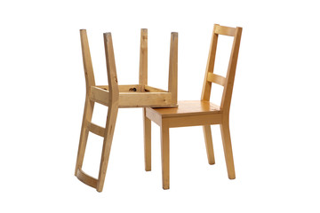 Two isolated wooden chairs stand on top of each other