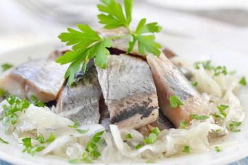 Salted herring fillet with oil, marinated onion and fresh parsley