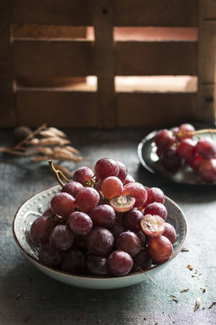 Purple grapes in a bowl. Vertical