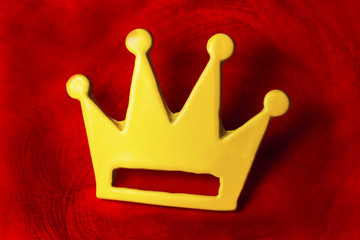 Yellow crown on red background.