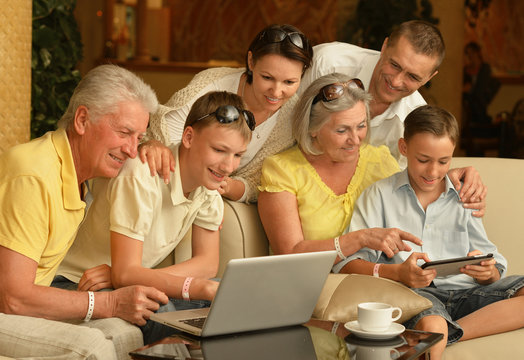 family sitting with digital devices