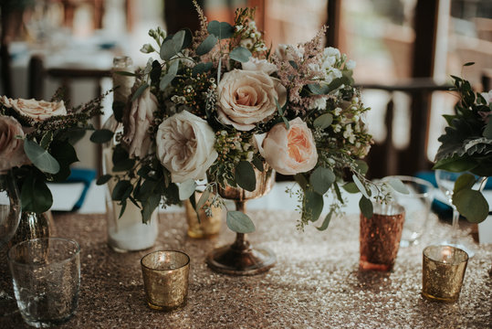 Elegant and romantic floral and shiny sequin table setting wedding decor