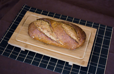 Rye bread with cereals on wooden table