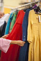 young girl chooses goods in a clothing store. The concept of shopping