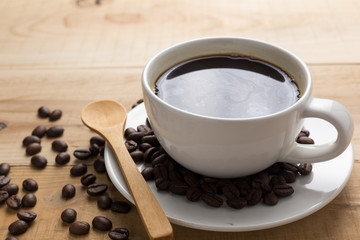 Coffee cup and coffee beans on table