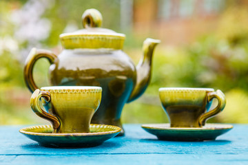 Teapot and cups on table