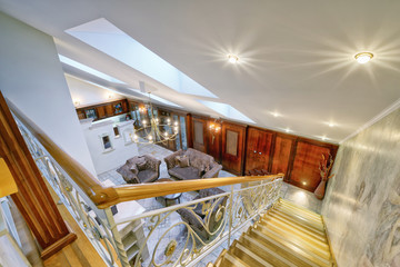 Russia,Moscow - modern living room interior. Duplex apartment with a stylish spiral staircase.