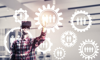 Guy wearing checked shirt and virtual mask demonstrating some em