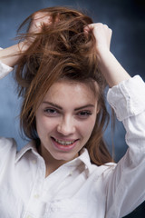 Portrait of young beautiful Happy smiling woman playing with her long hair. Female fashion. (Gestures, facial expressions, body language concept)