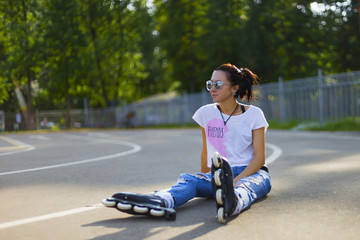 Fototapeta na wymiar Summer girl in Park rollerblading