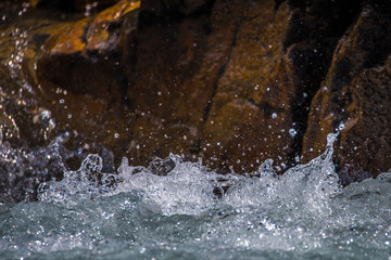 Splashes and drops of river water against a stone background. Shevelev.