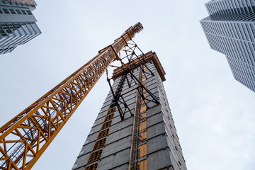 Crane attached to side of building at downtown construction site