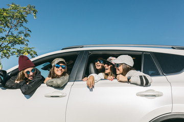 Group of girls inside a car looking each other